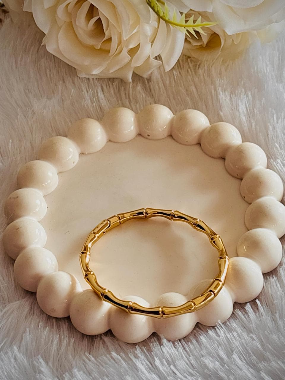 gold- toned circular bangle. bamboo-inspired segmented design.